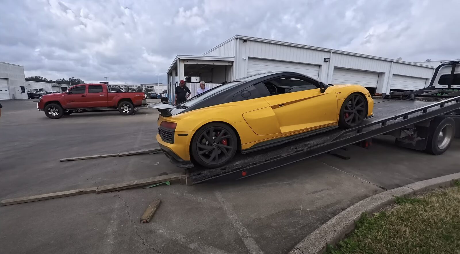 Luxury sports car being loaded for safe flatbed transport